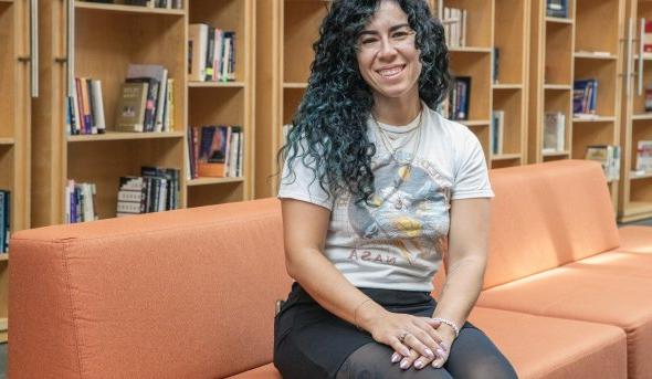 a woman sits on a couch